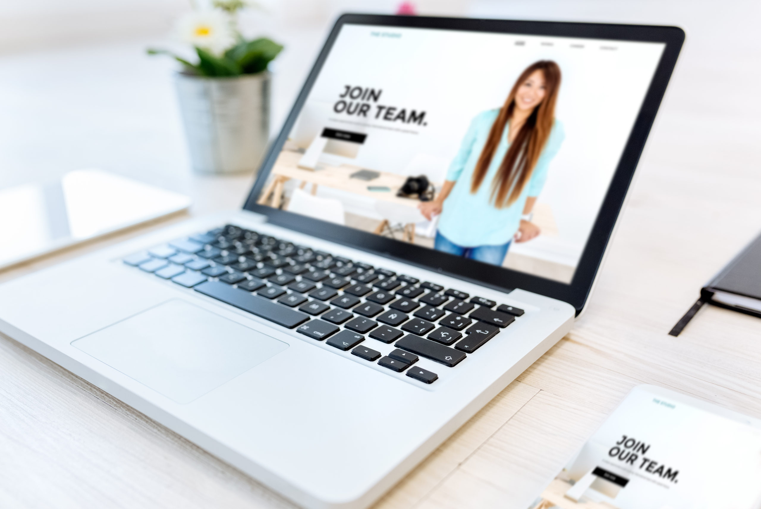 Company website Laptop and smartphone on a desktop showing a company website