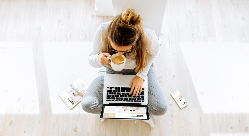 women sipping tea and working on computer