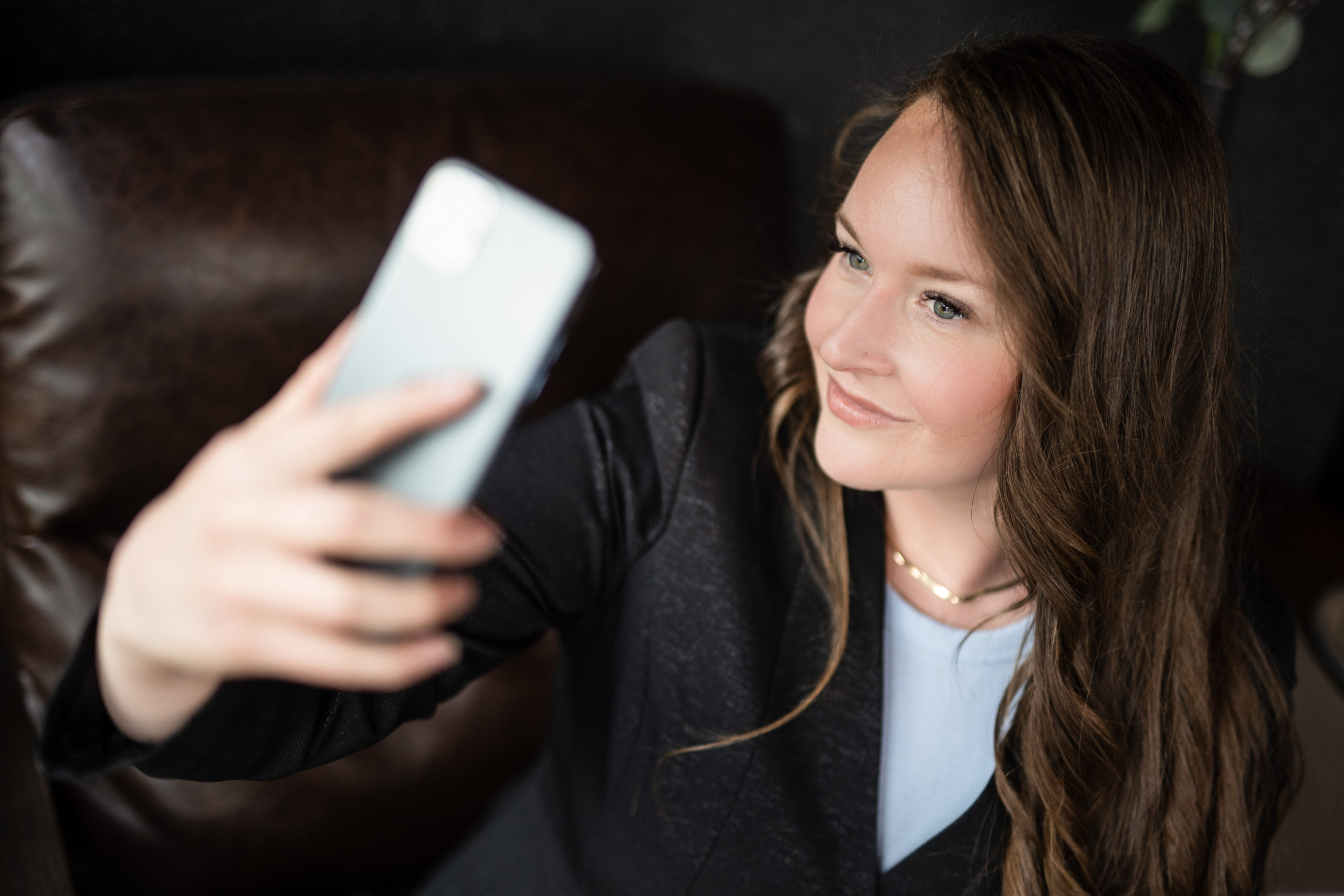 woman holding cellphone for selfie